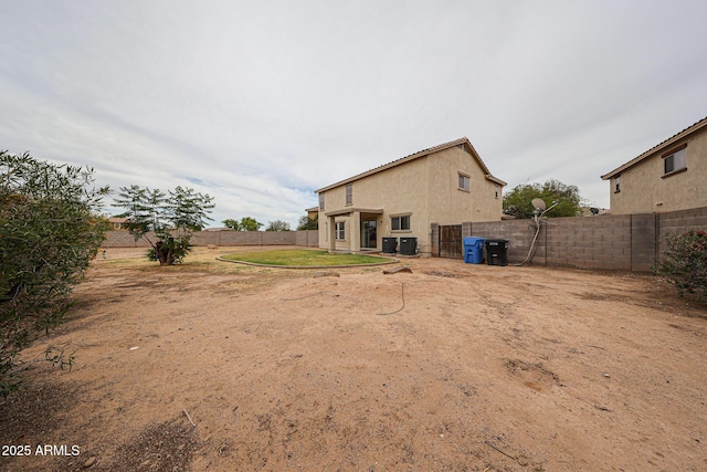 4804 S 25th Dr, Phoenix, AZ 85041 - rear view of house with a fenced backyard and stucco siding
