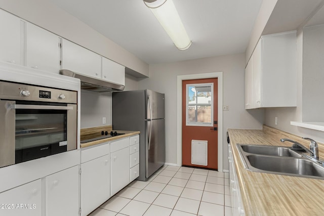 kitchen with under cabinet range hood, stainless steel appliances, a sink, white cabinets, and light countertops