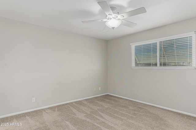 empty room with carpet flooring, ceiling fan, and baseboards