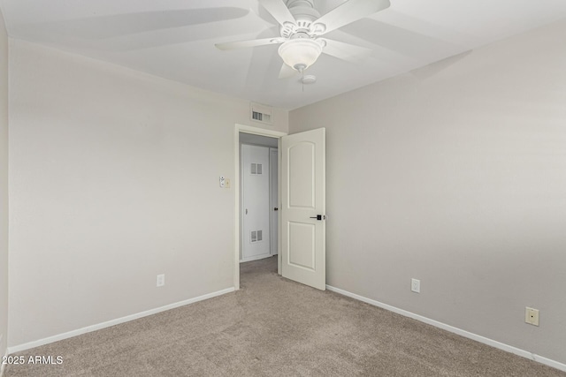 carpeted empty room with visible vents, ceiling fan, and baseboards