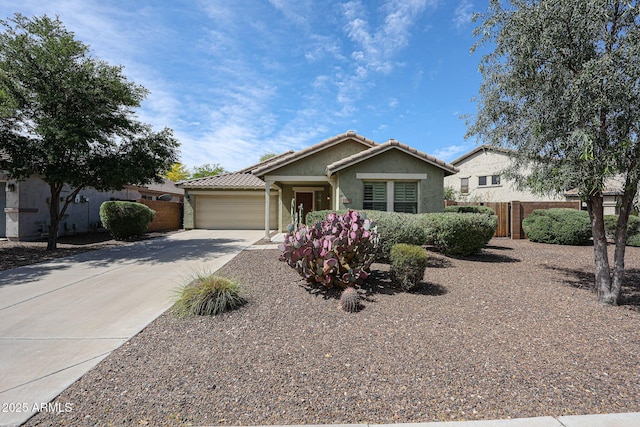 single story home featuring fence, an attached garage, a tile roof, stucco siding, and concrete driveway