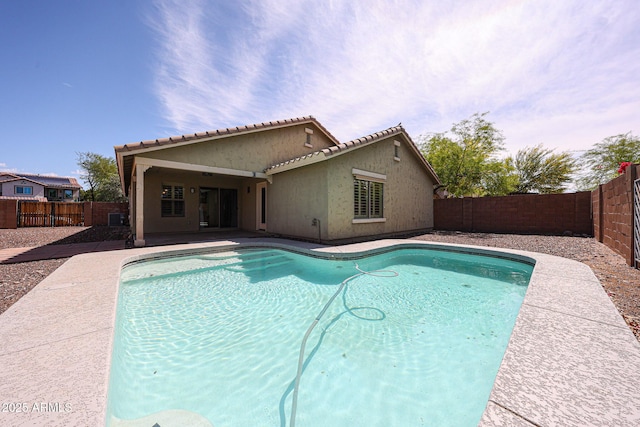 view of swimming pool featuring a fenced in pool, a fenced backyard, and a patio area