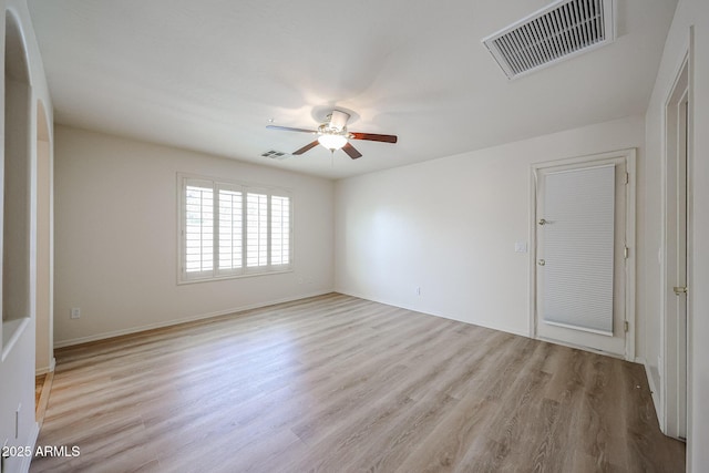 unfurnished room with baseboards, ceiling fan, light wood finished floors, and visible vents