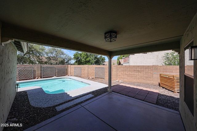view of pool featuring a fenced backyard and a patio
