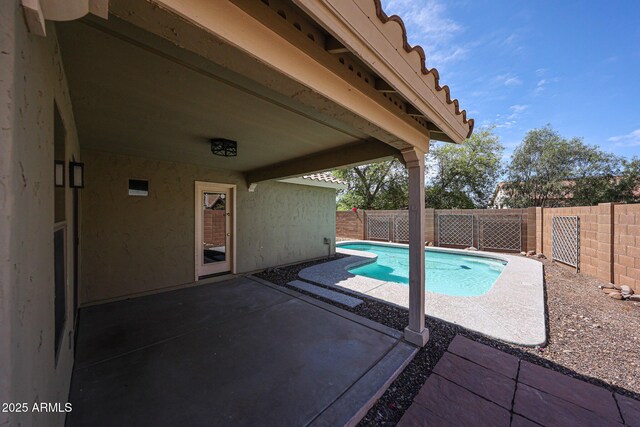 view of swimming pool featuring a fenced in pool, a fenced backyard, and a patio area