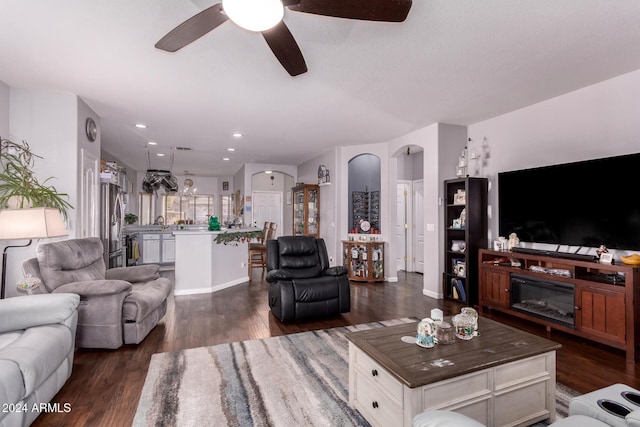 living room with dark hardwood / wood-style floors and ceiling fan