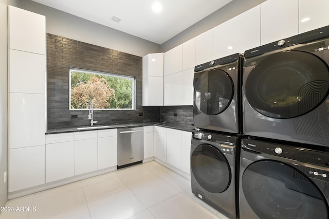 clothes washing area featuring sink, light tile patterned flooring, stacked washer / drying machine, and independent washer and dryer