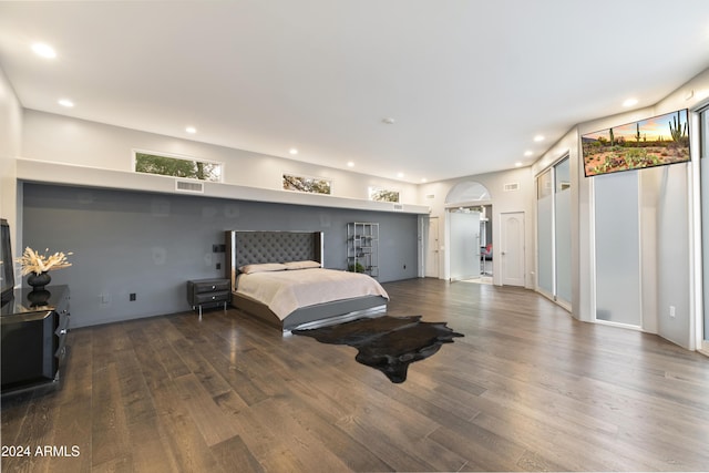 bedroom featuring visible vents, arched walkways, wood finished floors, and recessed lighting