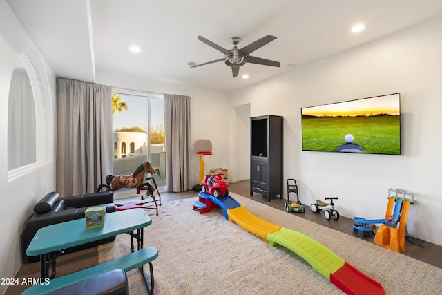 recreation room with ceiling fan and wood-type flooring