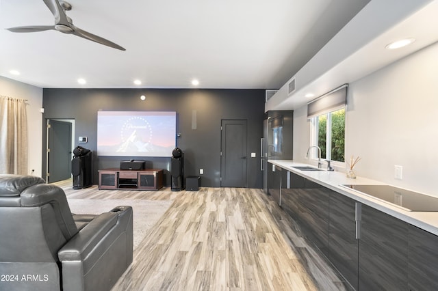 home theater with recessed lighting, a sink, visible vents, and light wood-style floors