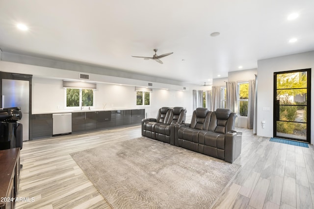 living room with light hardwood / wood-style flooring and ceiling fan