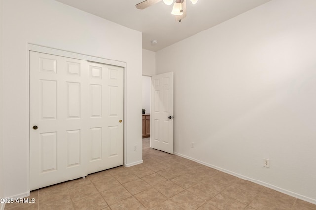 43142 N Outer Bank Dr, Anthem, AZ 85086 - unfurnished bedroom with a ceiling fan, light tile patterned floors, a closet, and baseboards