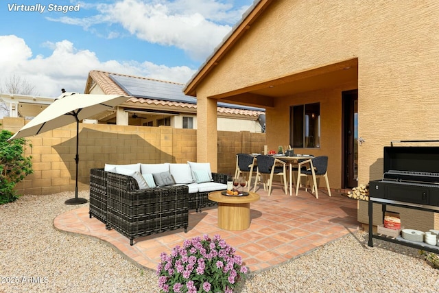 43142 N Outer Bank Dr, Anthem, AZ 85086 - view of patio with fence and an outdoor living space with a fire pit