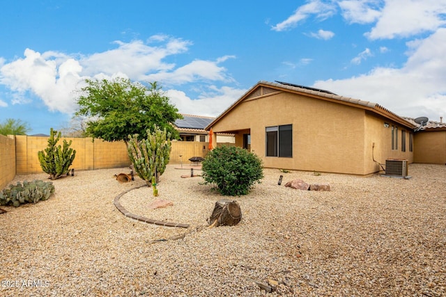 43142 N Outer Bank Dr, Anthem, AZ 85086 - view of home's exterior featuring central AC unit, roof mounted solar panels, stucco siding, and a fenced backyard