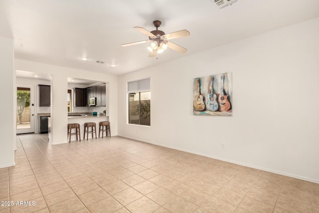 43142 N Outer Bank Dr, Anthem, AZ 85086 - empty room featuring baseboards, ceiling fan, visible vents, and light tile patterned floors