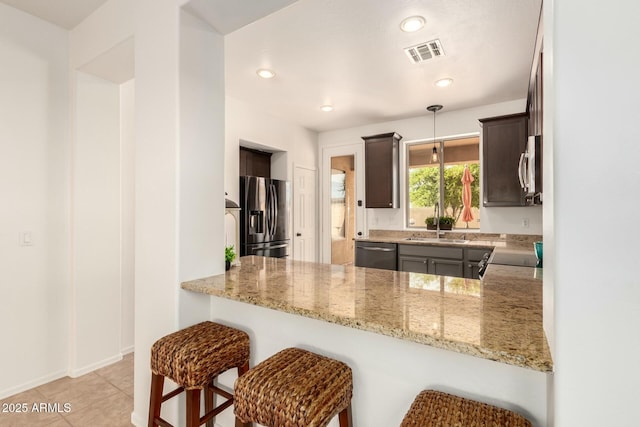 43142 N Outer Bank Dr, Anthem, AZ 85086 - kitchen with a peninsula, dark brown cabinetry, appliances with stainless steel finishes, and visible vents