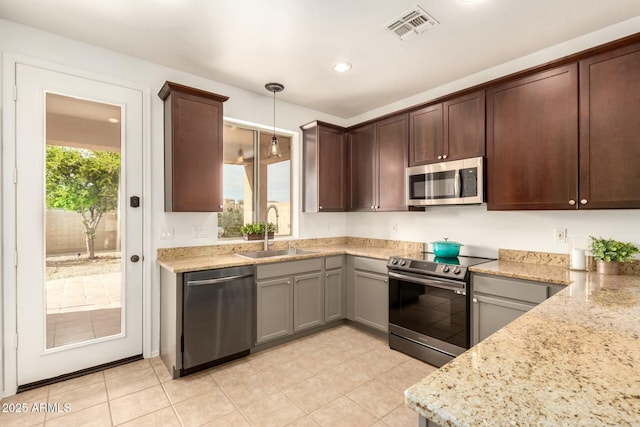 43142 N Outer Bank Dr, Anthem, AZ 85086 - kitchen with a sink, pendant lighting, stainless steel appliances, plenty of natural light, and visible vents