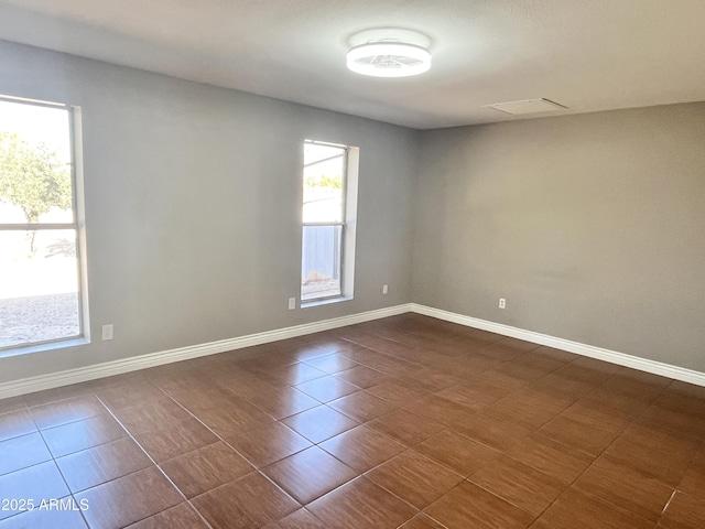 empty room with dark tile patterned flooring