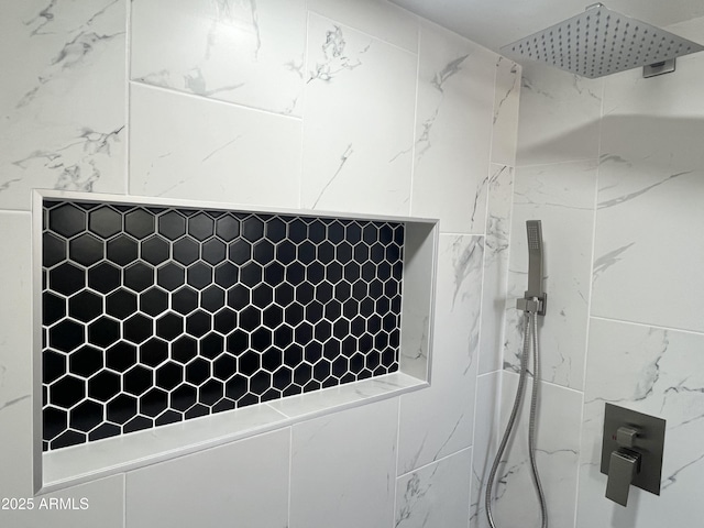 interior details featuring a tile shower