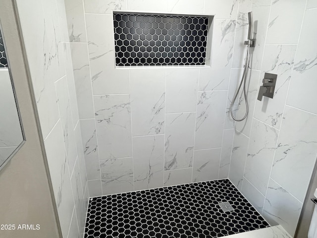 bathroom featuring tiled shower