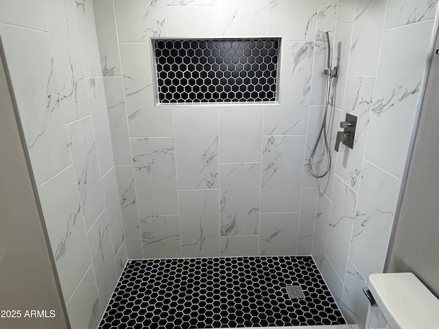 bathroom with tiled shower and toilet