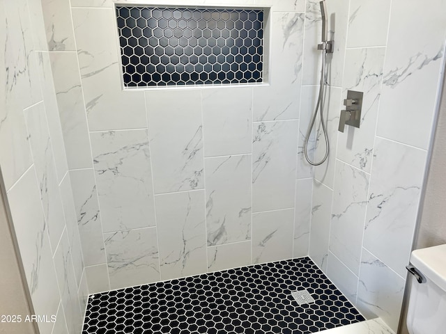 bathroom with tiled shower and toilet