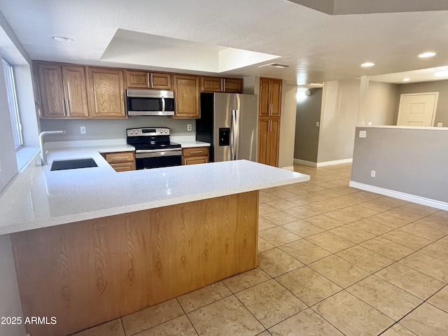 kitchen with sink, kitchen peninsula, stainless steel appliances, and light tile patterned floors