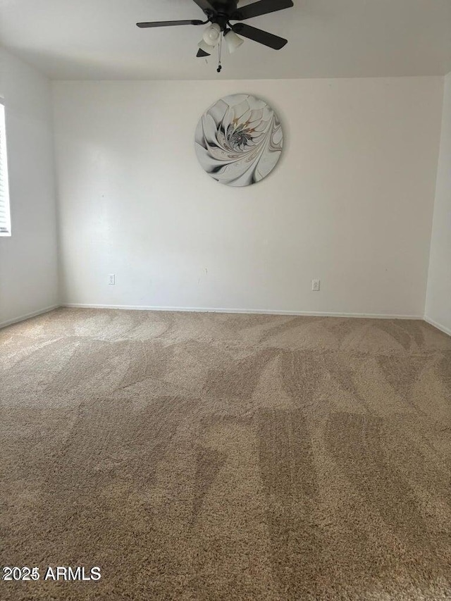 spare room with ceiling fan and carpet floors