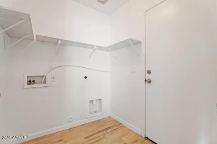 clothes washing area with hookup for a washing machine, gas dryer hookup, electric dryer hookup, and hardwood / wood-style floors