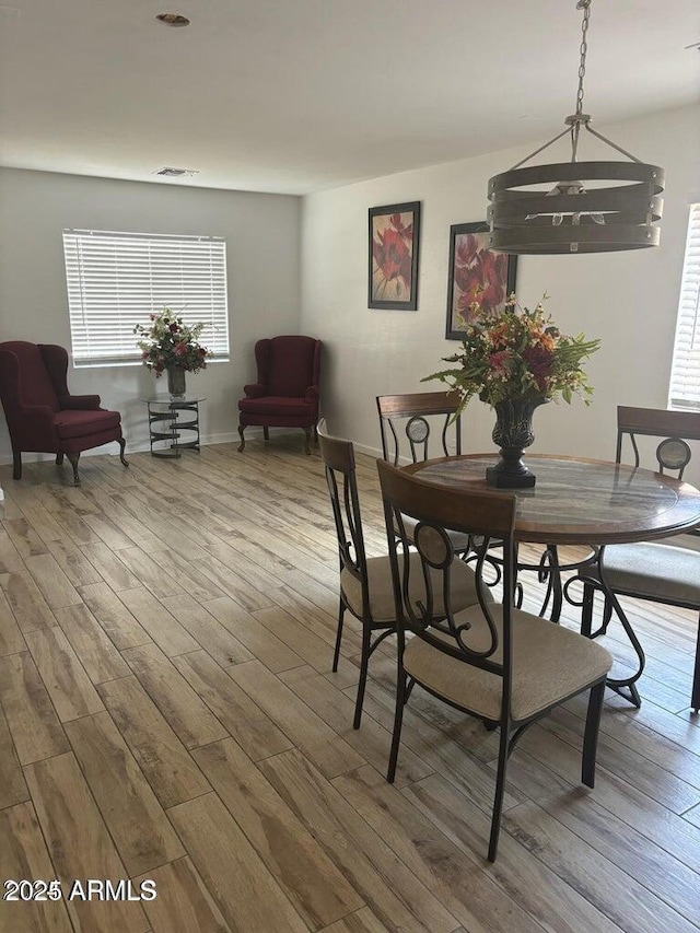 dining area featuring a notable chandelier and wood-type flooring