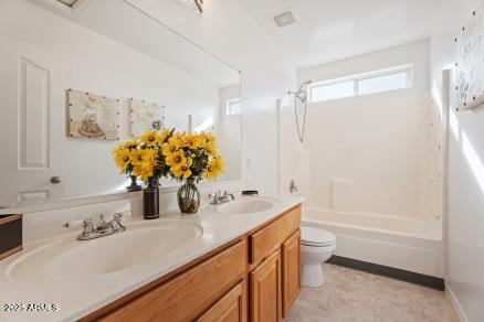 full bathroom featuring vanity, toilet, and bathing tub / shower combination