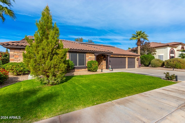 view of front facade with a garage and a front yard