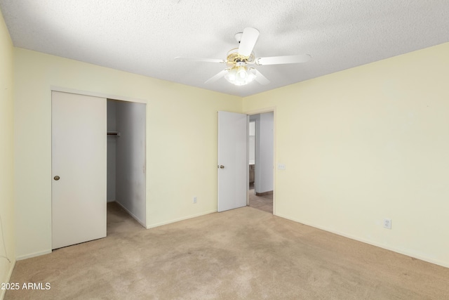3140 N 114th Dr, Avondale, AZ 85392 - unfurnished bedroom featuring a closet, baseboards, a textured ceiling, ceiling fan, and light colored carpet