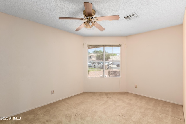 3140 N 114th Dr, Avondale, AZ 85392 - spare room featuring ceiling fan, a textured ceiling, visible vents, light carpet, and baseboards
