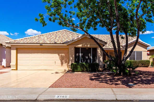 3140 N 114th Dr, Avondale, AZ 85392 - view of front facade featuring an attached garage, driveway, stucco siding, and a tile roof