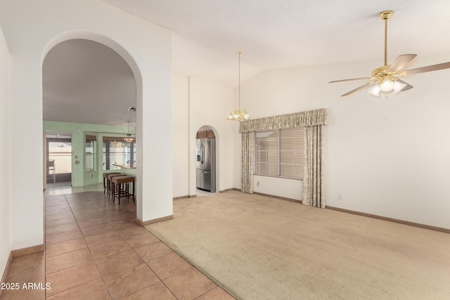 3140 N 114th Dr, Avondale, AZ 85392 - interior space featuring ceiling fan with notable chandelier, light tile patterned floors, arched walkways, light carpet, and baseboards