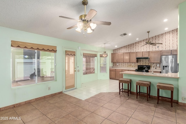3140 N 114th Dr, Avondale, AZ 85392 - kitchen featuring a ceiling fan, visible vents, black electric range, stainless steel fridge, and extractor fan