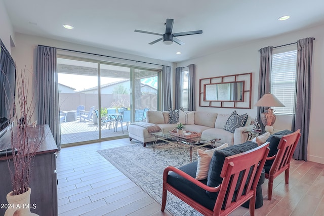 living room with light wood-type flooring and ceiling fan