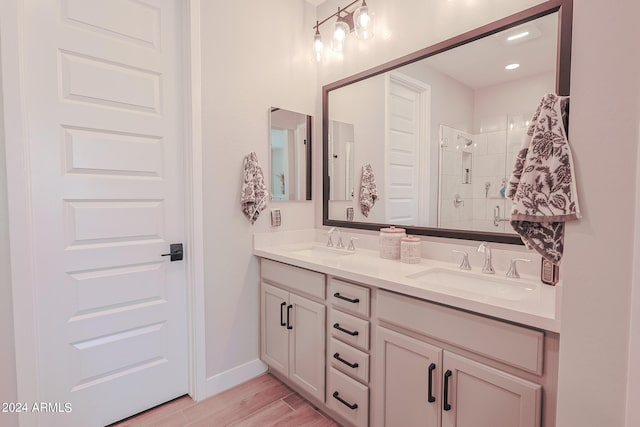 bathroom with walk in shower, vanity, and wood-type flooring