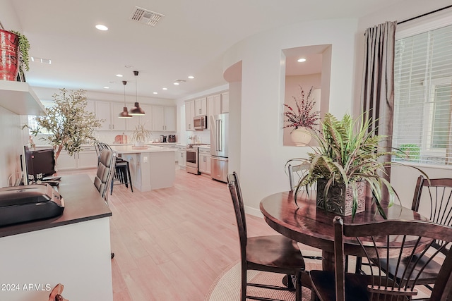 dining space featuring light wood-type flooring