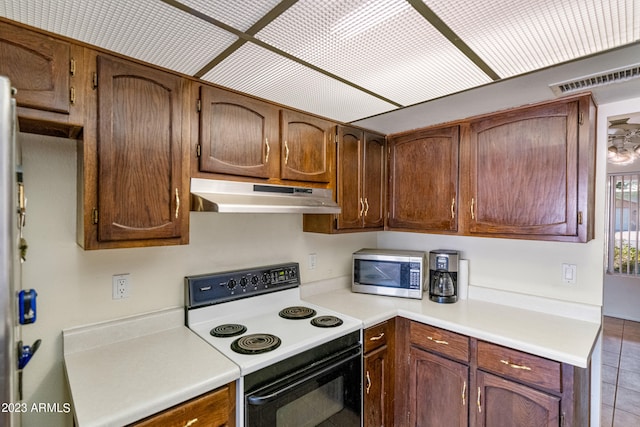 kitchen with white range with electric cooktop and tile floors