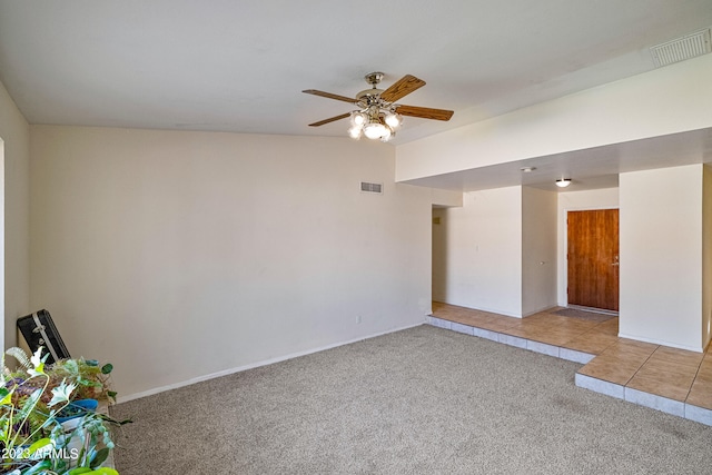 carpeted spare room featuring ceiling fan