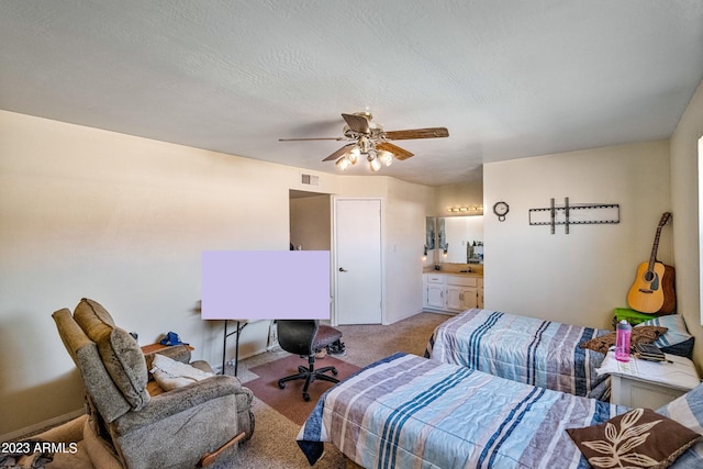 carpeted bedroom featuring ceiling fan and ensuite bathroom