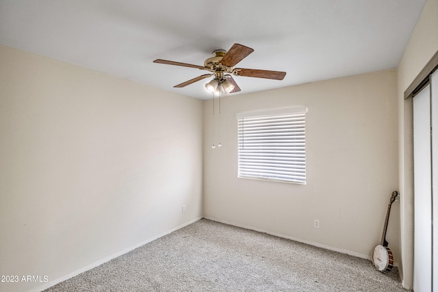 unfurnished room featuring ceiling fan and light carpet