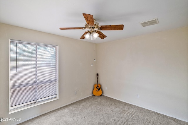 empty room with light colored carpet and ceiling fan