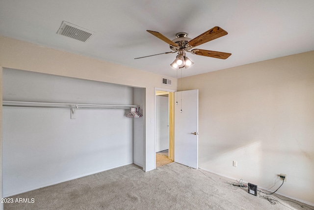 unfurnished bedroom with ceiling fan, a closet, and light carpet