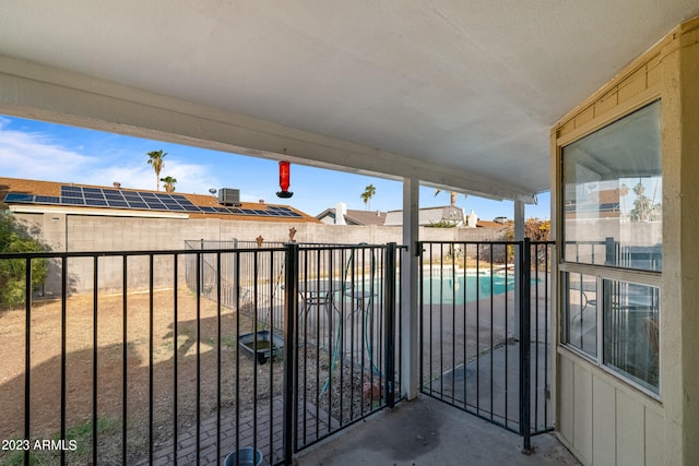 balcony featuring a fenced in pool