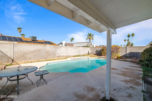 view of pool with central AC and a patio area