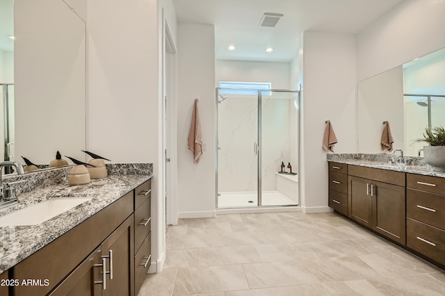 bathroom featuring two vanities, visible vents, a sink, and a shower stall