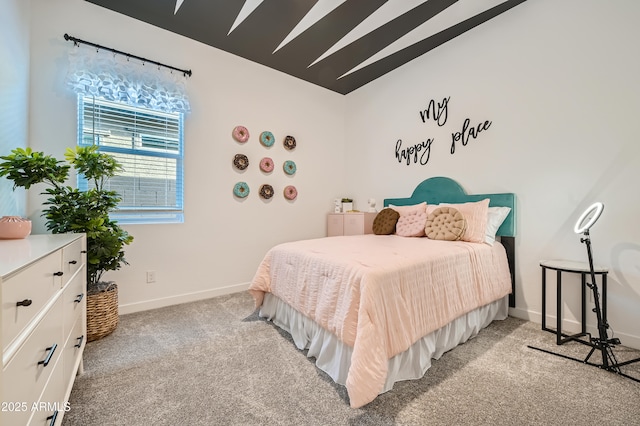 bedroom with lofted ceiling, light colored carpet, and baseboards